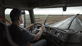 a person sitting at the dash of a Volvo truck